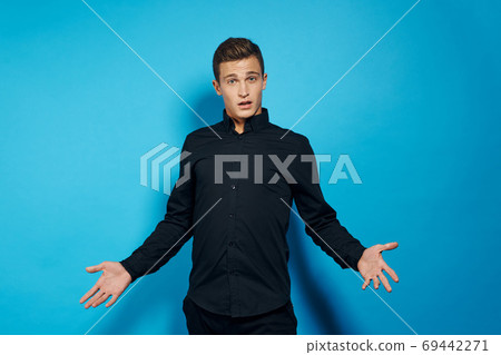 emotional man in black shirt studio lifestyle blue isolated background emotional man in black shirt studio lifestyle blue isolated background 69442271