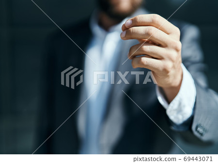 A business man outdoors holds the hand of an official close-up 69443071