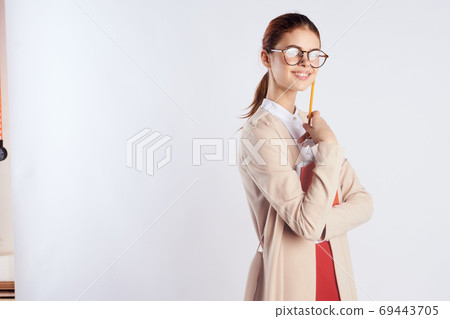 Happy female student with a notebook in hands and education science Light clothes glasses Red skirt 69443705