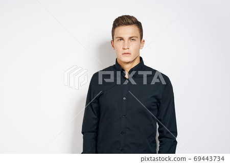 Man in black shirt lifestyle emotions modern style cropped view light background 69443734