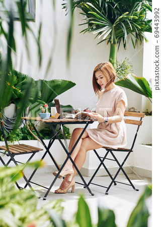 Young woman filling planner Young woman filling planner 69443992