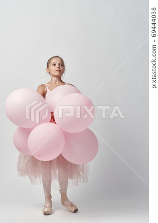 ballerina girl in costume with balloons in hands tutu pointe shoes dance 69444038
