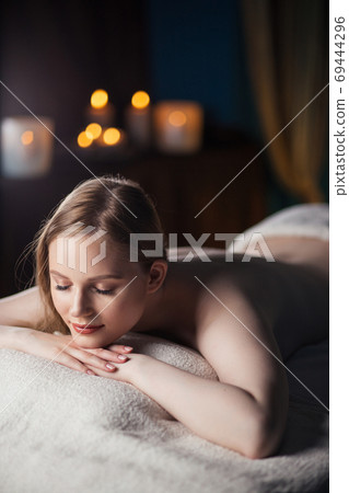 Half naked woman resting after massage 69444296