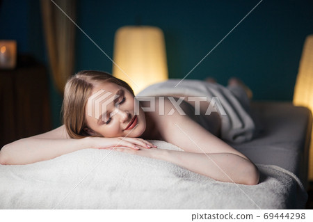 Half naked woman resting after massage 69444298