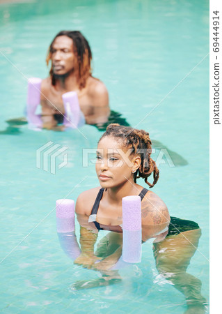 Couple doing water aerobics Couple doing water aerobics 69444914