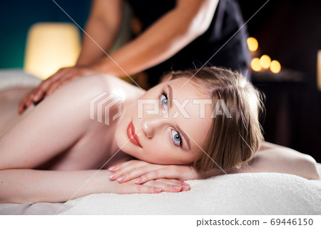 Portrait of a beautiful russian woman getting recreation body massage 69446150