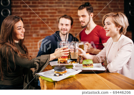 Group of mates enjoying night out at Burger Bar Group of mates enjoying night out at Burger Bar 69446206