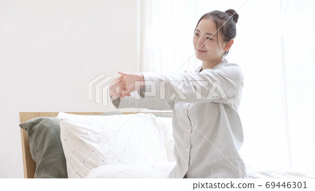 Young woman in pajamas waking up Young woman in pajamas waking up 69446301