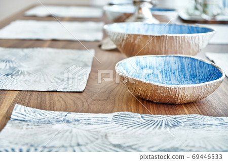 Dishware on wooden dinner table in modern apartment. Focus on background Dishware on wooden dinner table in modern apartment. Focus on background 69446533