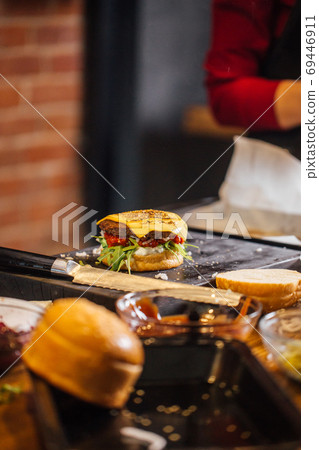 Process of cooking of tasty burger in burger bar 69446911