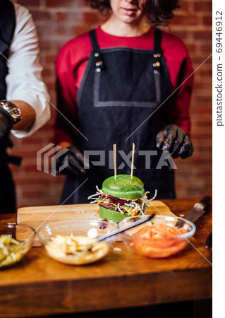 Fresh tasty burger and on wooden table 69446912