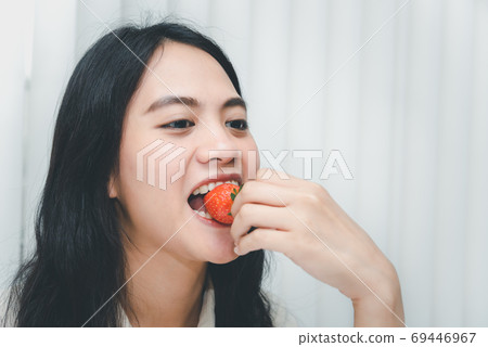 Woman eat strawberry red berry fruit sweet juicy Woman eat strawberry red berry fruit sweet juicy 69446967