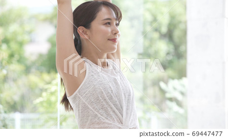 A young woman stretching A young woman stretching 69447477