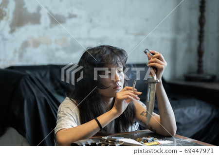 Asian girl smoking and feeling be absent-minded Asian girl smoking and feeling be absent-minded 69447971
