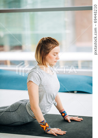 Yoga woman doing stretching exercise on the floor Yoga woman doing stretching exercise on the floor 69448210