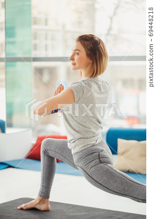 Beautiful sporty fit yogini woman practices yoga asana Virabhadrasana 2 - warrior pose 2 Beautiful sporty fit yogini woman practices yoga asana Virabhadrasana 2 - warrior pose 2 69448218