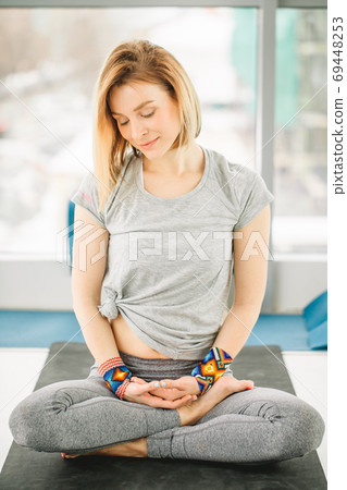 Sporty attractive woman sitting in Lotus pose Sporty attractive woman sitting in Lotus pose 69448253