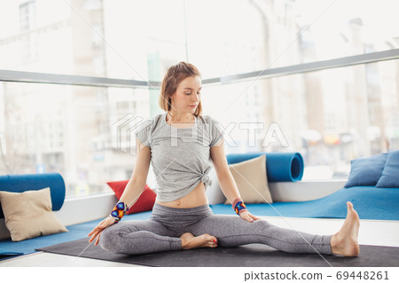 Woman performing yoga pose on mat, healthy lifestyle and fitness concept Woman performing yoga pose on mat, healthy lifestyle and fitness concept 69448261