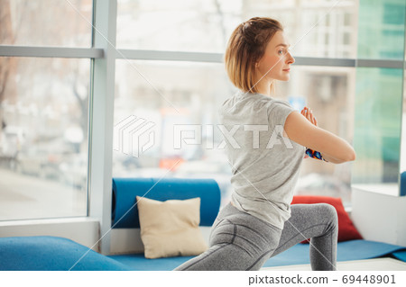 Beautiful sporty fit yogini woman practices yoga asana Virabhadrasana 2 - warrior pose 2 69448901