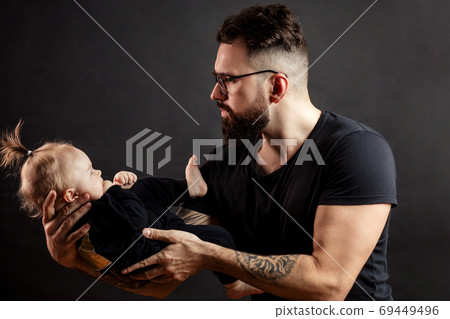 handsome father holding his cute newborn baby handsome father holding his cute newborn baby 69449496