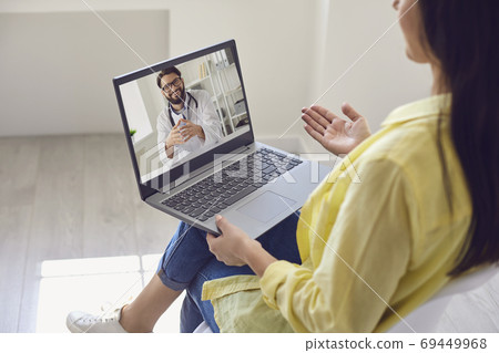 Doctor online. Young woman using video call and laptop to chat with doctor. Doctor online. Young woman using video call and laptop to chat with doctor. 69449968