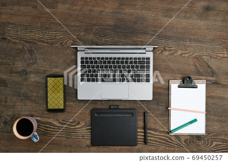 Flat layout of graphic tablet with stylus, mobile gadgets and other supplies 69450257