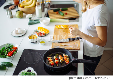 Top view of unrecognizable woman cutting fresh oranges with knife. Top view of unrecognizable woman cutting fresh oranges with knife. 69450578