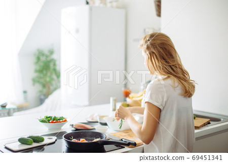Closeup of woman roasting kebabs on frying pan 69451341