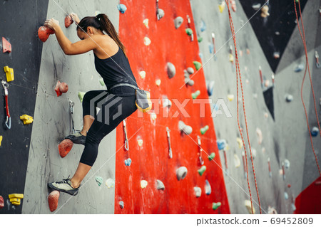 teenage girl in a free climbing wall teenage girl in a free climbing wall 69452809
