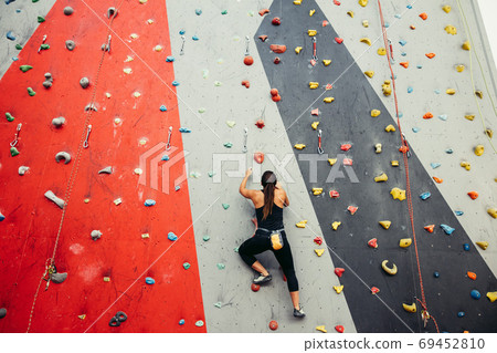 teenage girl in a free climbing wall teenage girl in a free climbing wall 69452810