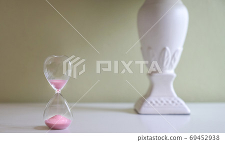 Sand glass on white table 69452938