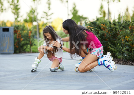 little child girl falled down while rolling with her mother 69452951