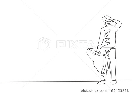 One single line drawing of young happy male guitarist standing and holding acoustic guitar case One single line drawing of young happy male guitarist standing and holding acoustic guitar case 69453218