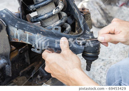 Auto Mechanic or Car Mechanic Tighten Upper Arm Ball Joint Nut Auto Mechanic or Car Mechanic Tighten Upper Arm Ball Joint Nut 69453429