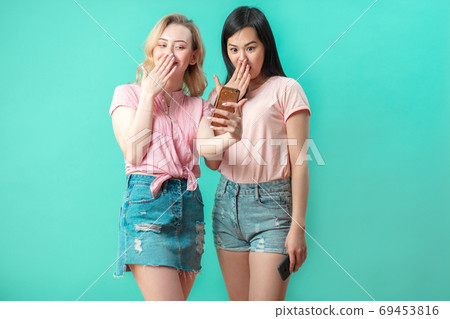 two multiethnic beautiful women asian and caucasian taking selfie at studio two multiethnic beautiful women asian and caucasian taking selfie at studio 69453816