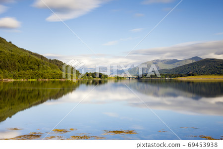 Loch Leven. A long exposure of the view across Loch Leven from Ballachulish towards Ballachulish Bridge in the Scottish highlands. Loch Leven is a sea loch on the west coast of Scotland. Loch Leven. A long exposure of the view across Loch Leven from Ballachulish towards Ballachulish Bridge in the Scottish highlands. Loch Leven is a sea loch on the west coast of Scotland. 69453938