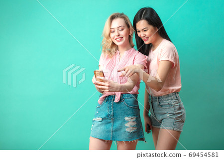 two multiethnic beautiful women asian and caucasian taking selfie at studio two multiethnic beautiful women asian and caucasian taking selfie at studio 69454581