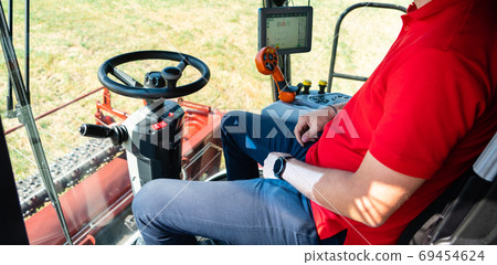 Unmanned autonomous harvester on the field 69454624