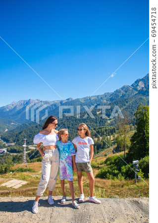 Beautiful happy family in mountains in the background of fog. Beautful landscape Beautiful happy family in mountains in the background of fog. Beautful landscape 69454718