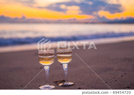 two glasses on the white sandy beach two glasses on the white sandy beach 69454720
