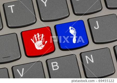 Printout of hand and foot on computer keys Printout of hand and foot on computer keys 69455122