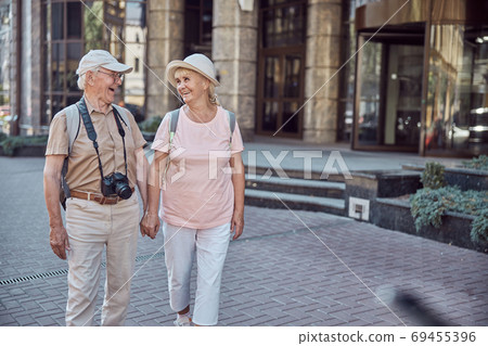 Man with a digital camera looking at his wife 69455396