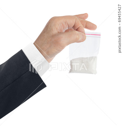 Hand and packet with narcotic Hand and packet with narcotic 69455427