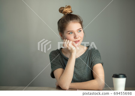 thoughtful young pretty woman wearing hair in knot. Contemplation concept. thoughtful young pretty woman wearing hair in knot. Contemplation concept. 69455698