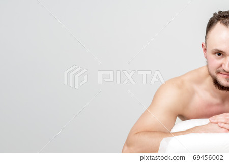 Man lying on front on table spa Man lying on front on table spa 69456002