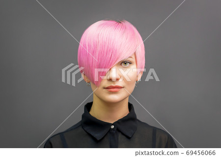 Woman with short bright pink hair Woman with short bright pink hair 69456066