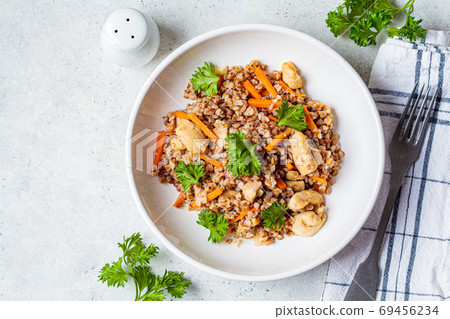 Buckwheat with chicken meat and vegetables in a white plate Buckwheat with chicken meat and vegetables in a white plate 69456234