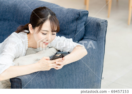 A woman using a smartphone A woman using a smartphone 69457153