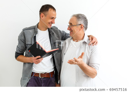 Senior father with adult son talking, isolated white background. Senior father with adult son talking, isolated white background. 69457516