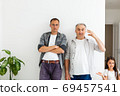 Senior father with adult son talking, isolated white background. 69457541